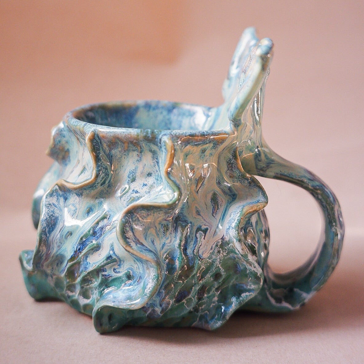Handcrafted mermaid mug with a beautifully glazed finish, featuring a whimsical tail-shaped handle and ocean-inspired design, perfect for adding a touch of enchantment to your morning routine