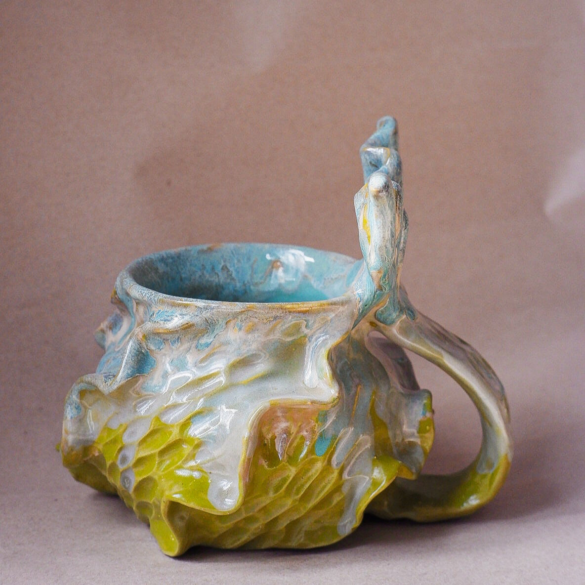 Handcrafted mermaid mug with a beautifully glazed finish, featuring a whimsical tail-shaped handle and ocean-inspired design, perfect for adding a touch of enchantment to your morning routine