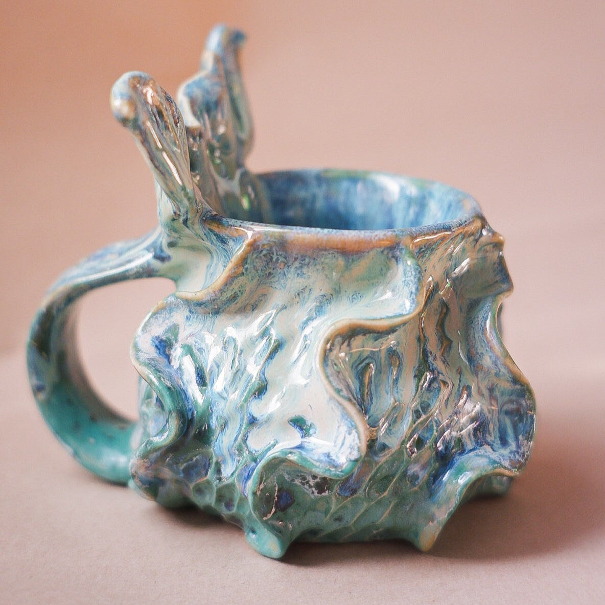 Handcrafted mermaid mug with a beautifully glazed finish, featuring a whimsical tail-shaped handle and ocean-inspired design, perfect for adding a touch of enchantment to your morning routine