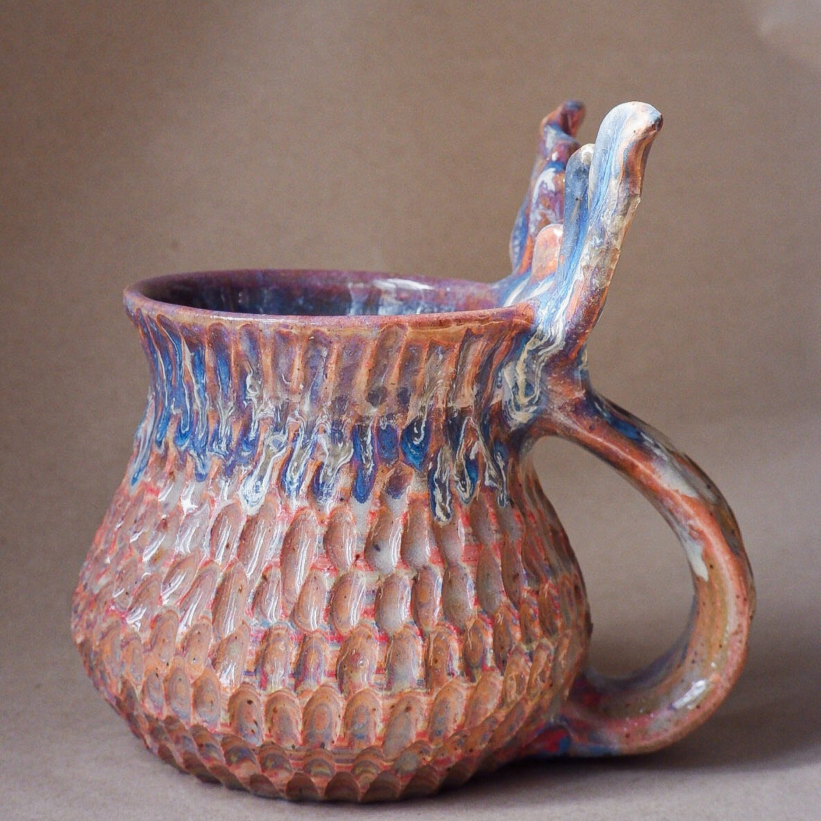 Handcrafted mermaid mug with a beautifully glazed finish, featuring a whimsical tail-shaped handle and ocean-inspired design, perfect for adding a touch of enchantment to your morning routine