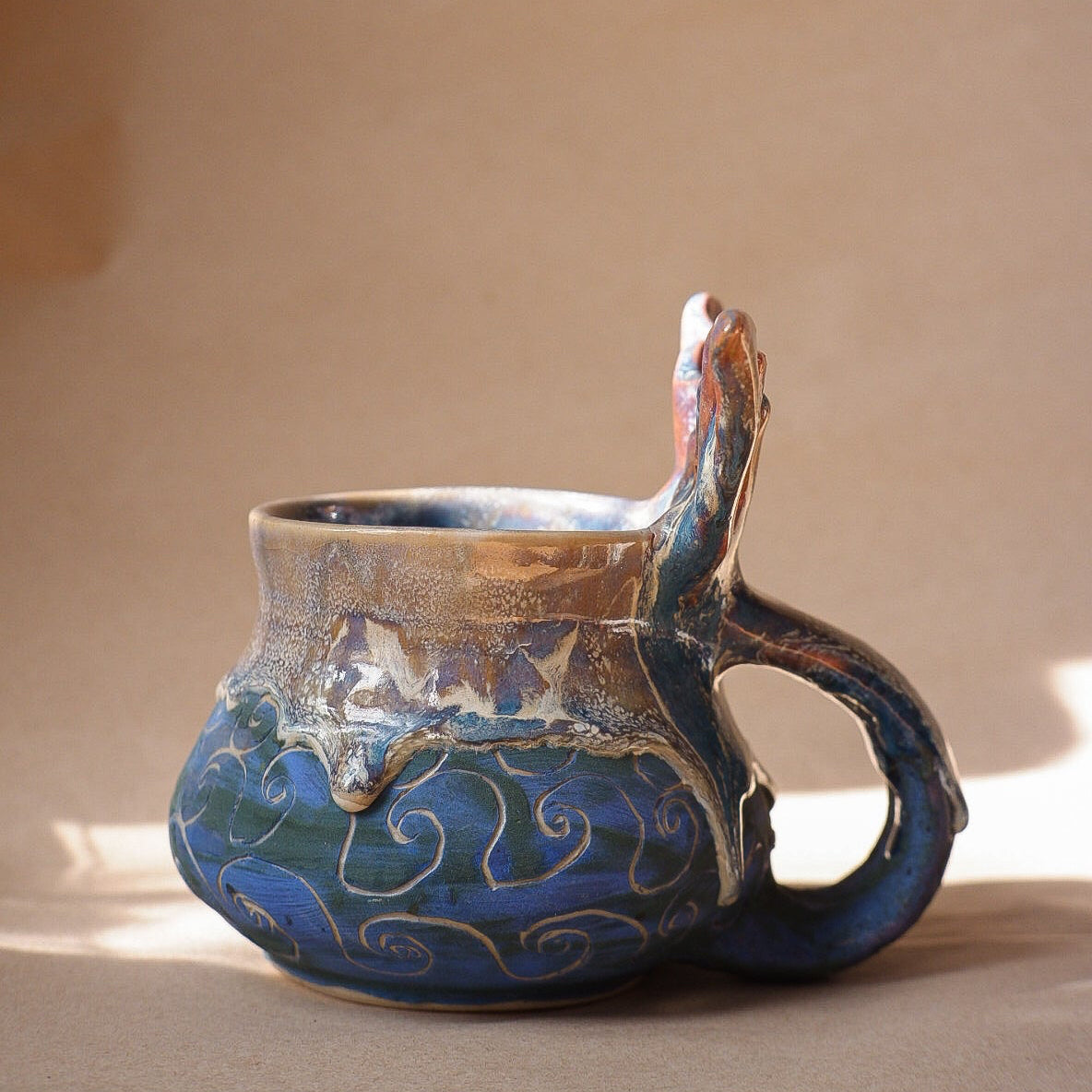 Handcrafted mermaid mug with a beautifully glazed finish, featuring a whimsical tail-shaped handle and ocean-inspired design, perfect for adding a touch of enchantment to your morning routine