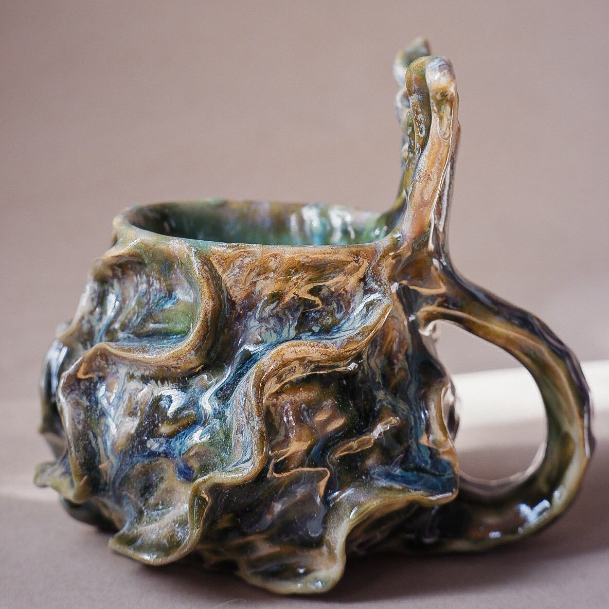Handcrafted mermaid mug with a beautifully glazed finish, featuring a whimsical tail-shaped handle and ocean-inspired design, perfect for adding a touch of enchantment to your morning routine