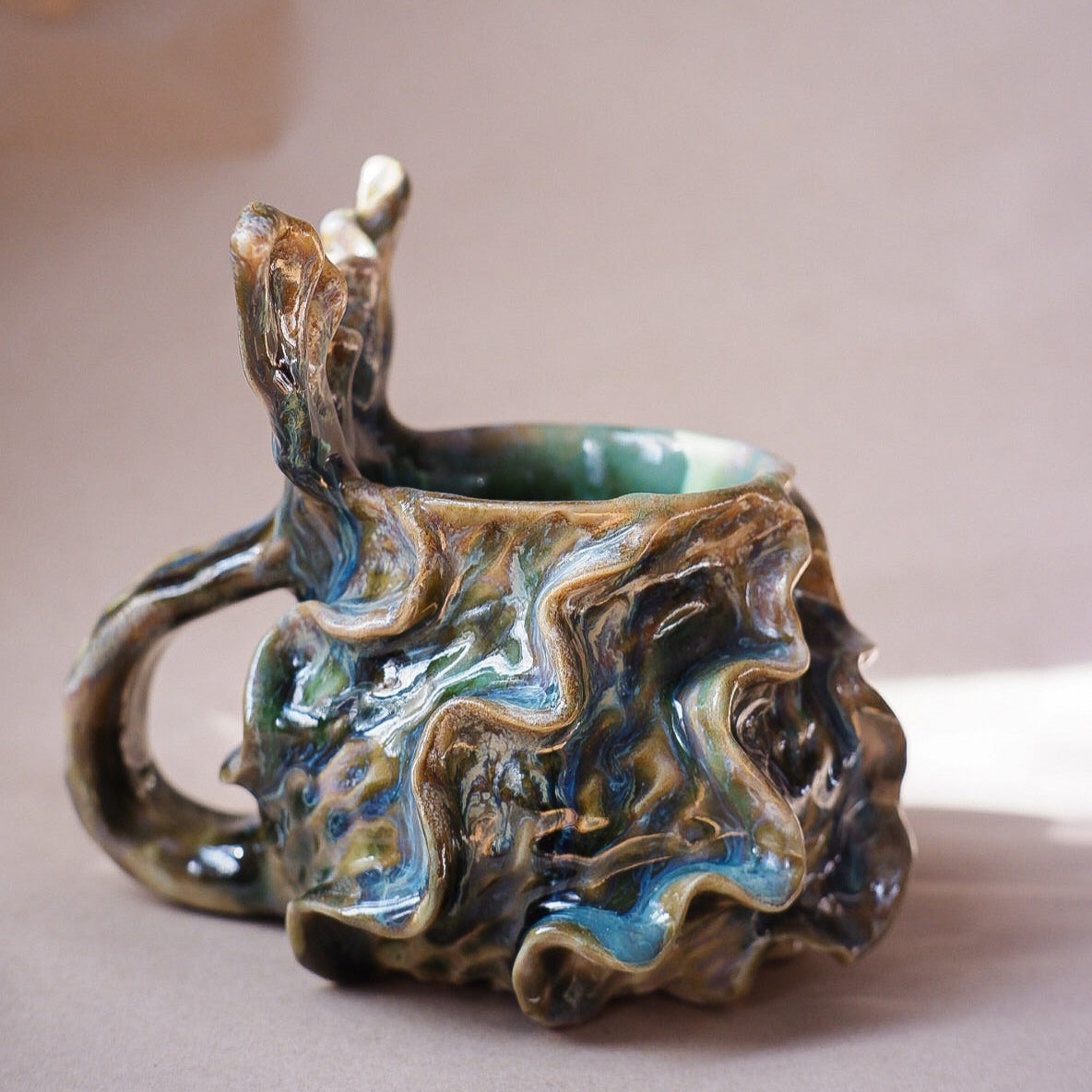 Handcrafted mermaid mug with a beautifully glazed finish, featuring a whimsical tail-shaped handle and ocean-inspired design, perfect for adding a touch of enchantment to your morning routine