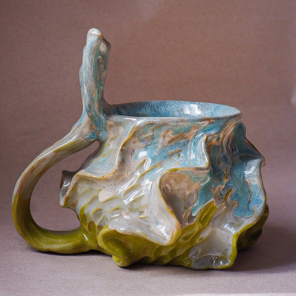 Handcrafted mermaid mug with a beautifully glazed finish, featuring a whimsical tail-shaped handle and ocean-inspired design, perfect for adding a touch of enchantment to your morning routine