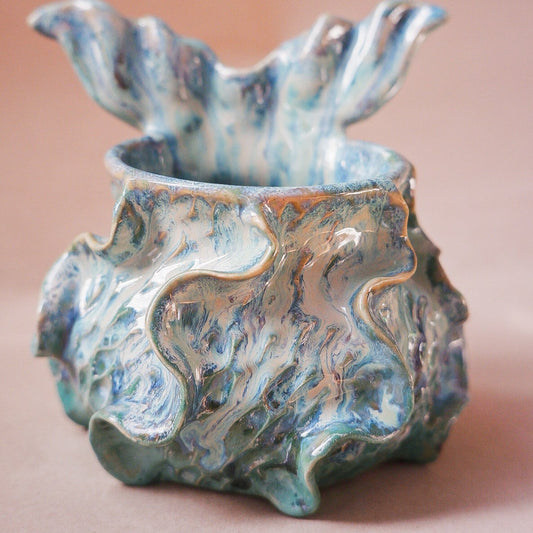 Handcrafted mermaid mug with a beautifully glazed finish, featuring a whimsical tail-shaped handle and ocean-inspired design, perfect for adding a touch of enchantment to your morning routine