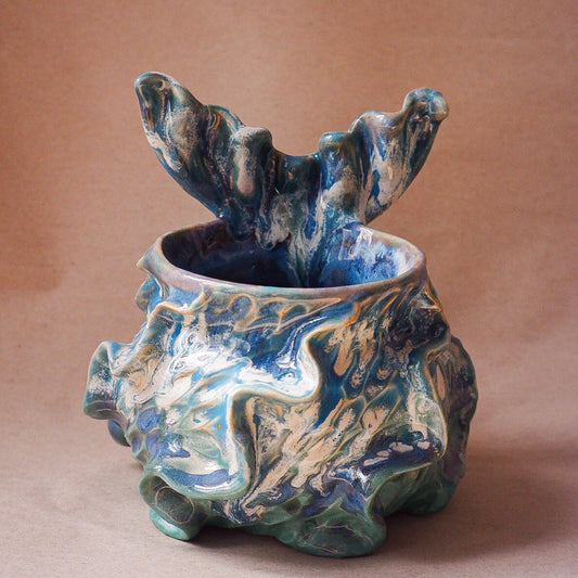 Handcrafted mermaid mug with a beautifully glazed finish, featuring a whimsical tail-shaped handle and ocean-inspired design, perfect for adding a touch of enchantment to your morning routine