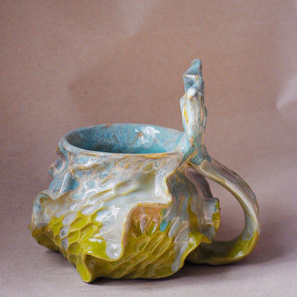 Handcrafted mermaid mug with a beautifully glazed finish, featuring a whimsical tail-shaped handle and ocean-inspired design, perfect for adding a touch of enchantment to your morning routine