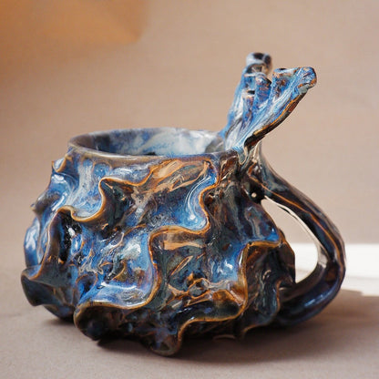Handcrafted mermaid mug with a beautifully glazed finish, featuring a whimsical tail-shaped handle and ocean-inspired design, perfect for adding a touch of enchantment to your morning routine