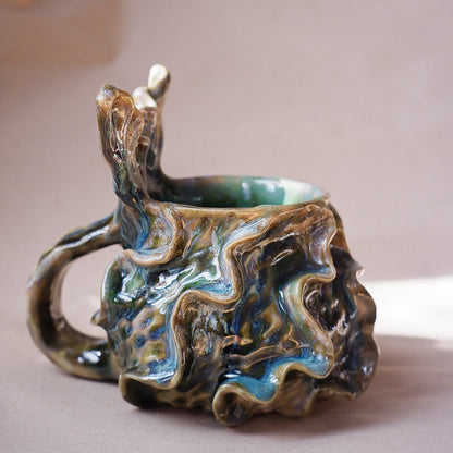 Handcrafted mermaid mug with a beautifully glazed finish, featuring a whimsical tail-shaped handle and ocean-inspired design, perfect for adding a touch of enchantment to your morning routine
